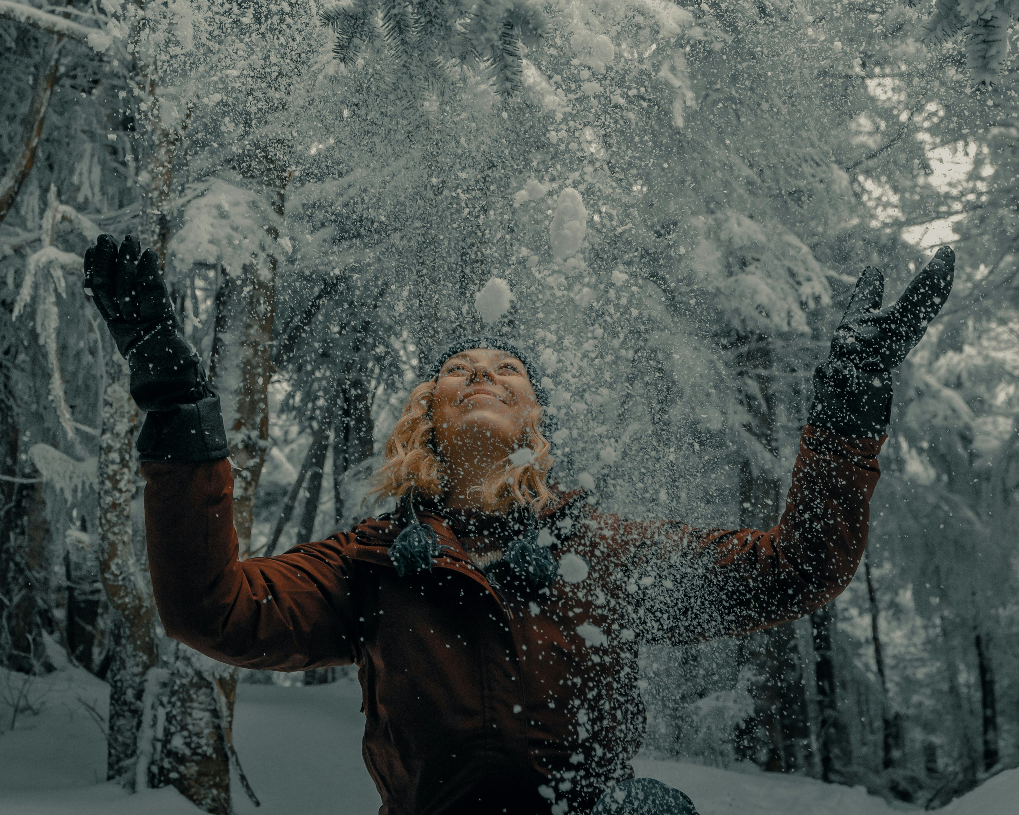 woman in black jacket blowing snow